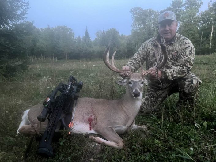 Male hunter with whitetail deer