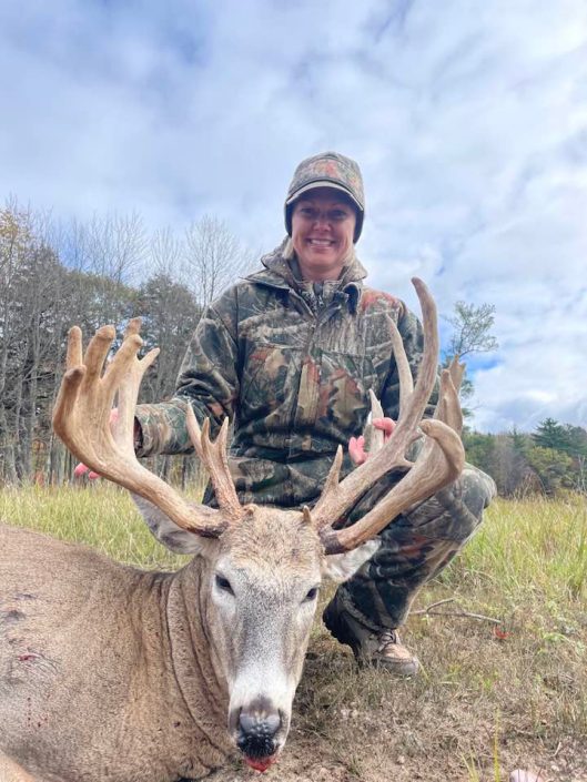 Woman hunter and buck