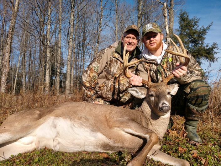 Hunter with guide and buck