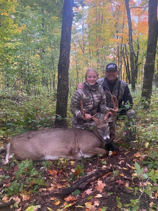 father and daughter with killed deer