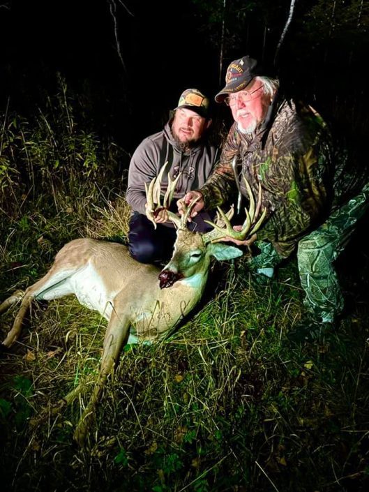 two men with buck shot at night