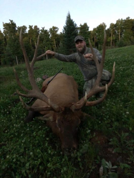 a hunter with his trophy bull elk 