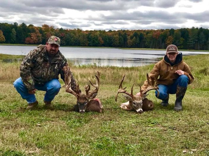 two hunter show of their won whitetail trophies 