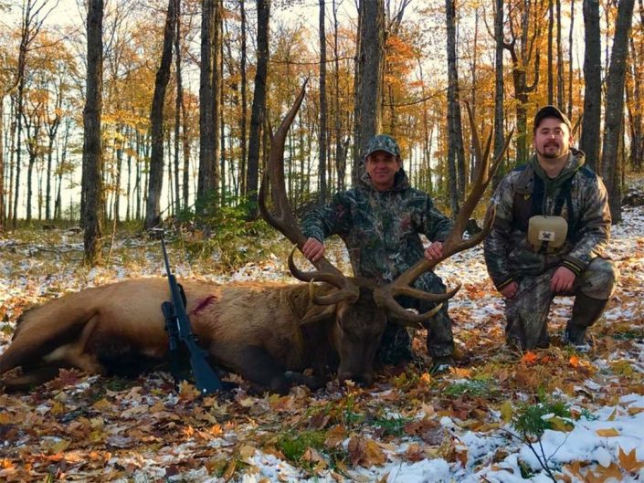 A hunter with a bull elk 