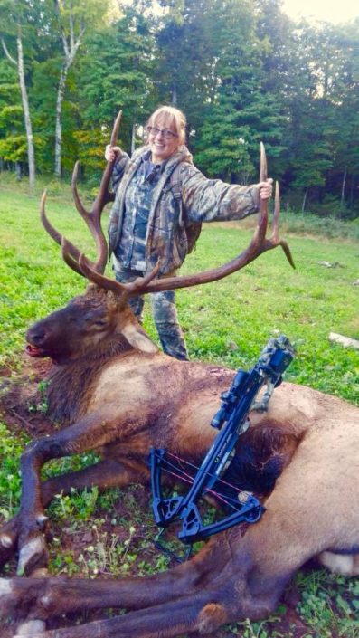 a hunter with a bull elk 