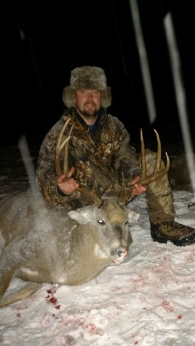 a hunter with a whitetail buck 