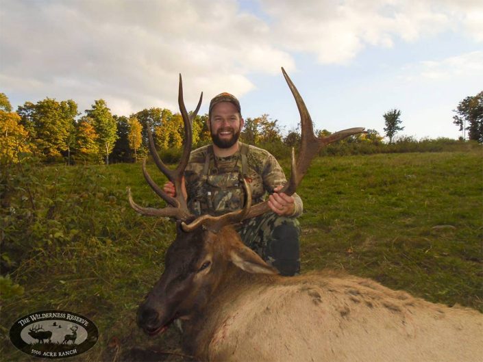 a hunter shows off an elk they have hunted 