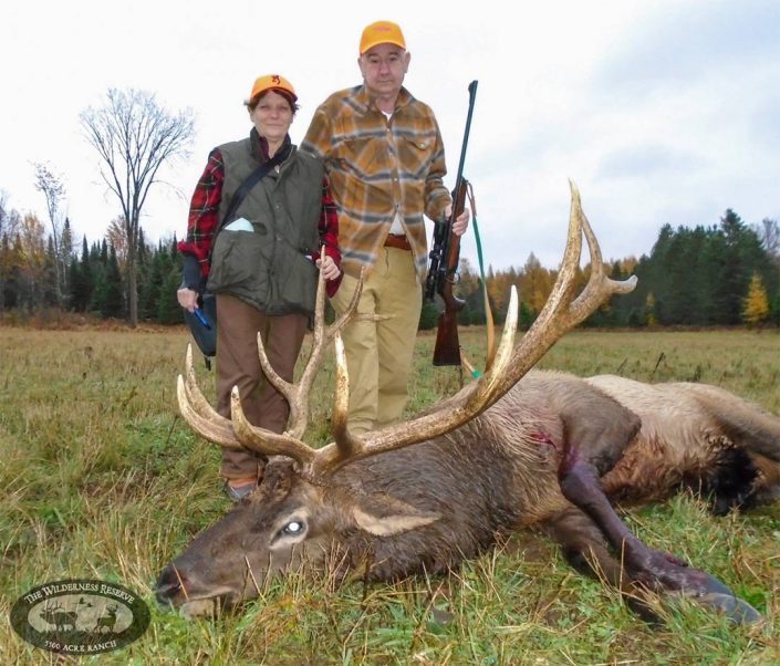 two hunters with their trophy buck with large antlers 