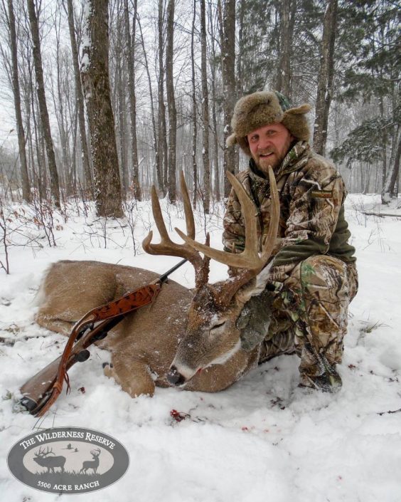 A man with his trophy buck kill