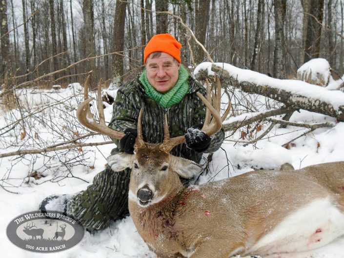 A hunter shows off the Buck they have killed 