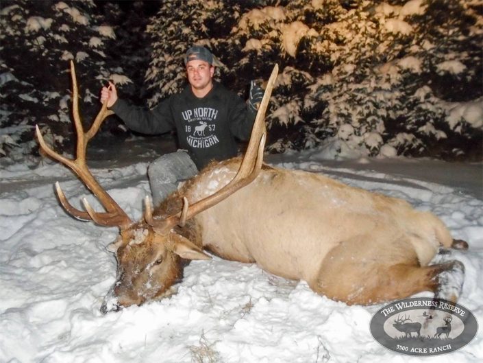 A hunter shows off a trophy bull elk 