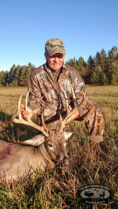A hunter with his whitetail buck 