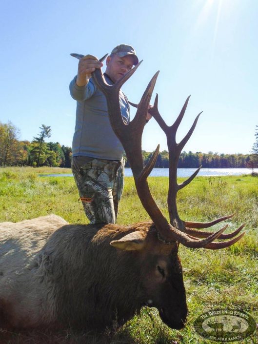 a hunter with his trophy elk 