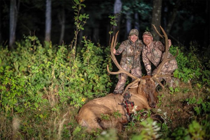 a pair pose with an elk kill 