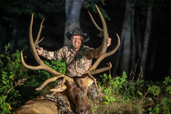 a hunter with his bull Elk 
