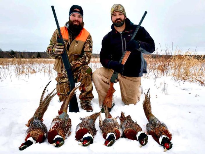 two hunters with their pheasant harvest 