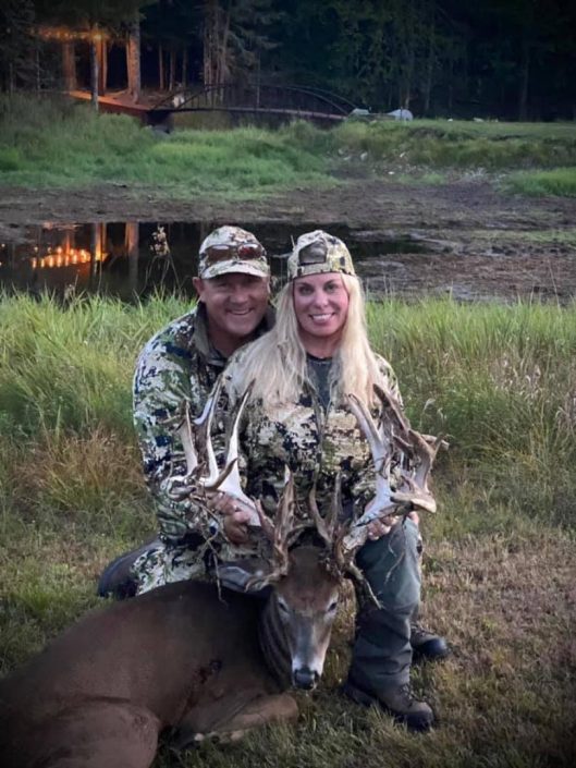 two hunters with a whitetail buck 