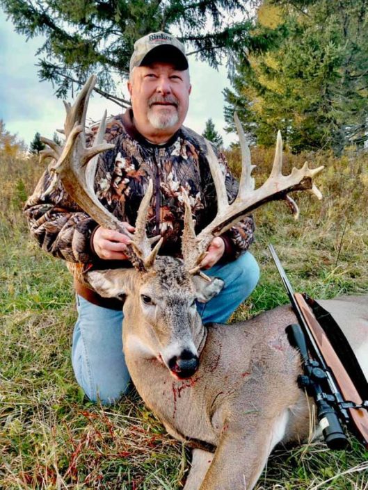 A man and his whitetail deer trophy