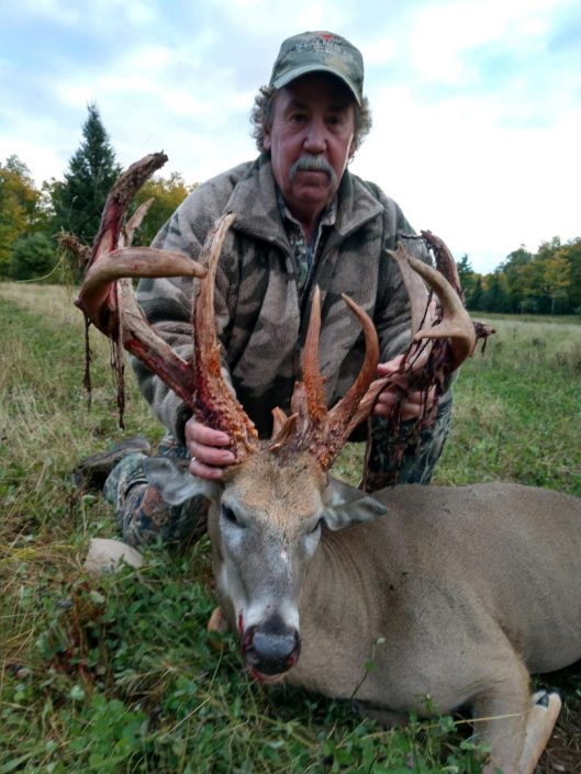 A hunter with a whitetail deer 