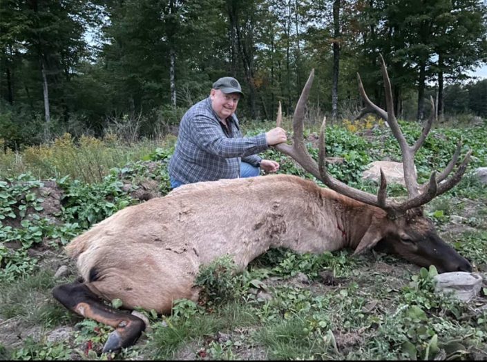 a hunter with an elk 