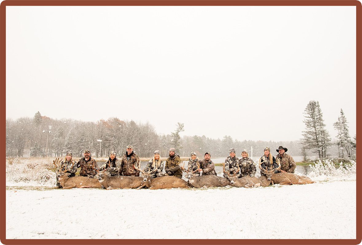 Group with trophy animals after hunting retreat