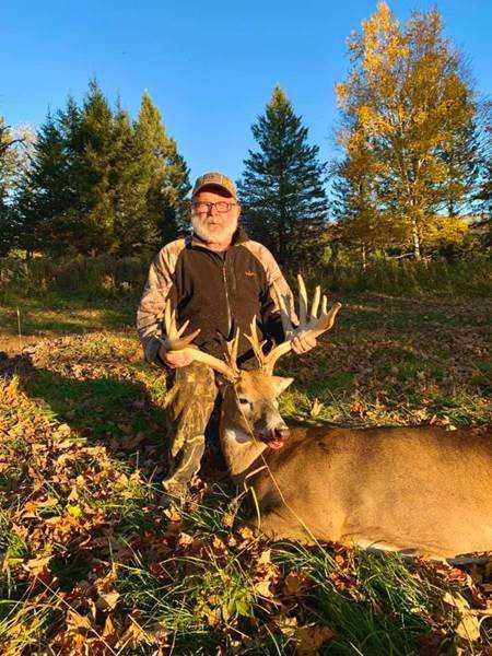 older man with deer kill