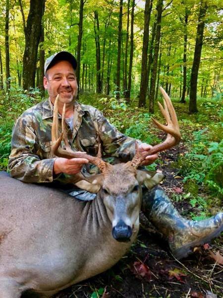 man with successful deer kill