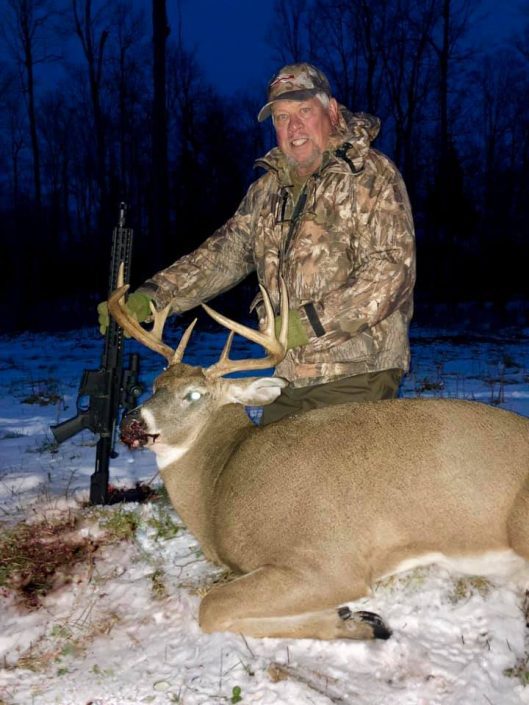 man with deer kill